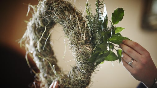 Learning how to make seasonal decorations at a Christmas event at Killerton, Devon